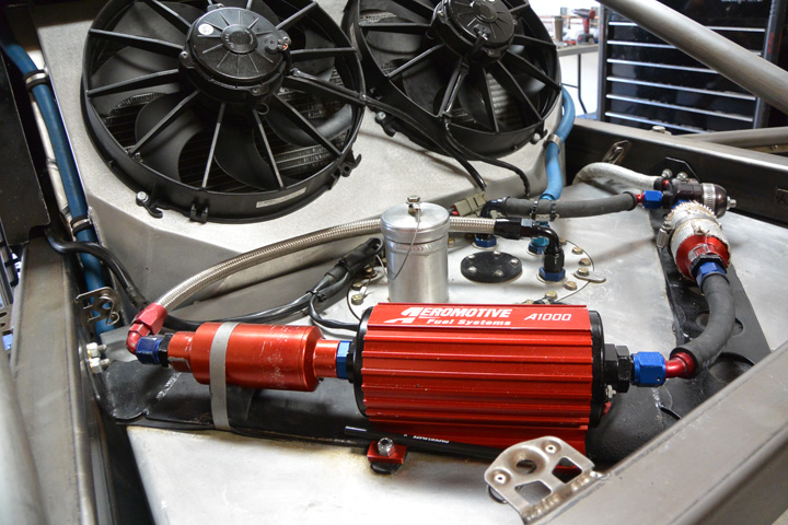 An Aeromotive fuel system provides a steady flow of fuel to the Ford V-8 come race time. The fuel system is mounted high and in an easily accessible position on top of the fuel cell, should something need to be changed out quickly.